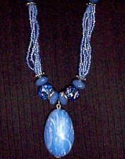 rhapsody in blue, strands, necklace, pendant, seed beads, hand painted, oval, silvertone, bead caps, toggle closure